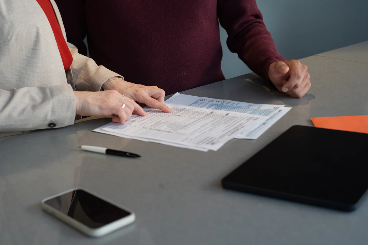 Two people reviewing paperwork together at a table